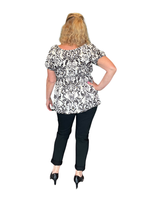 Valloittava lyhythihainen off shoulder pusero kultatehosteilla.