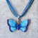 Kimalteleva sininen / turkoosi emaloitu perhonen kaulakoru