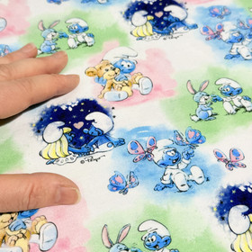 Smurffit -trikookangas: Baby Smurffit, valkoinen - sininen - vihreä - vaaleanpunainen 