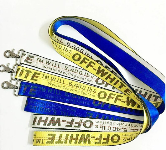 Turvavyövaljaiden välikappale, leveä, keltainen tekstillä