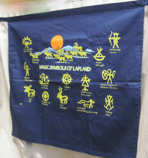 Esiliina tummansininen vyötäröessu kultaisin noitarumpumerkein