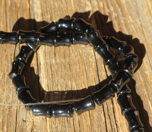 Onyksi musta kurvikas sylinteri 12x7-8mm irtohelmi