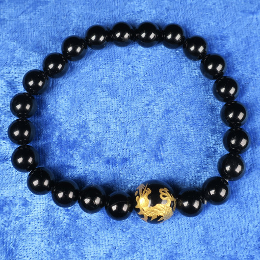 Rannekoru musta onyksi, kullattu lohikäärme