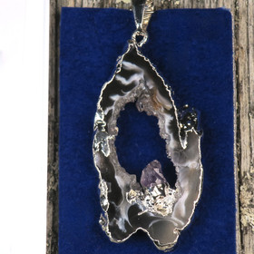 Riipus akaattisiivu, jonka keskellä ametistikide nro AKAM48