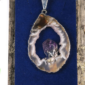 Riipus akaattisiivu, jonka keskellä ametistikide nro AKAM47