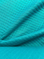 Puuvillamusliini tikattu turkoosi