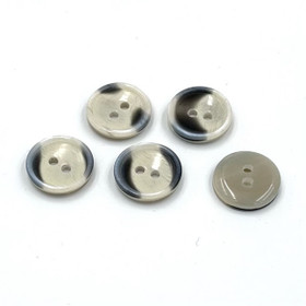 Kellertävä kuvioitu muovinappi 