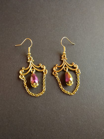 Hanging gold coloring earrings with purple drop