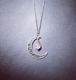 Crescent moon with pink droplet