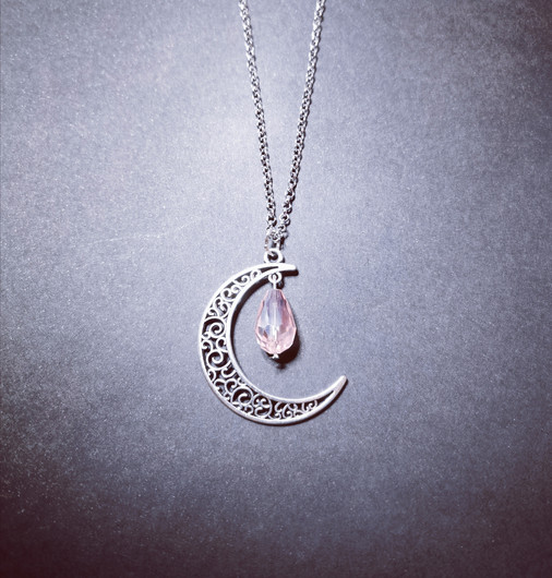 Crescent moon with pink droplet
