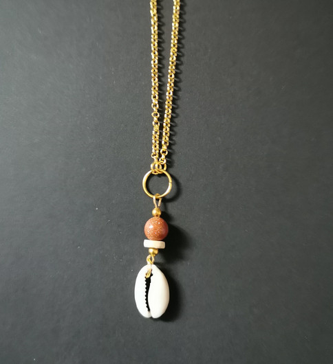 Clam necklace with a sandstone bead