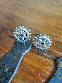silver-colored gear cuff-links
