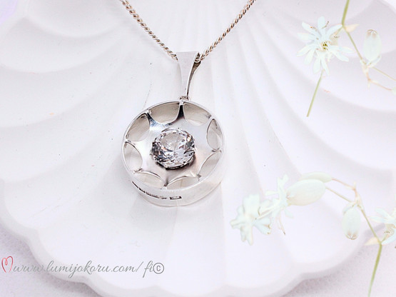 Hopeinen riipus kirkkaalla kivellä