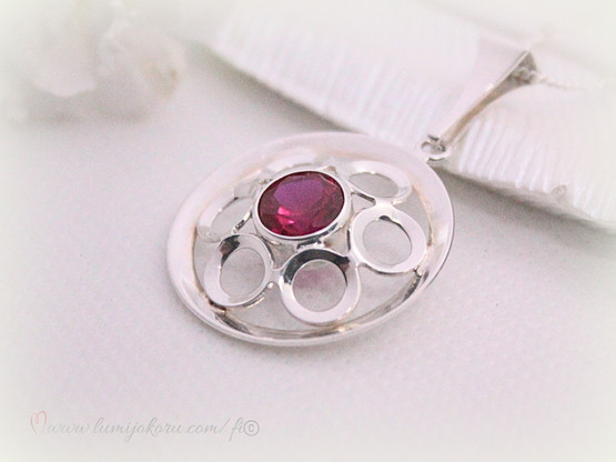 Hopeinen riipus punaisella kivellä