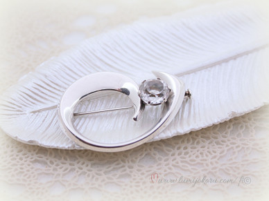 Rintakoru kirkkaalla kivellä hopeaa