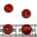 Punaoranssi puristenappi